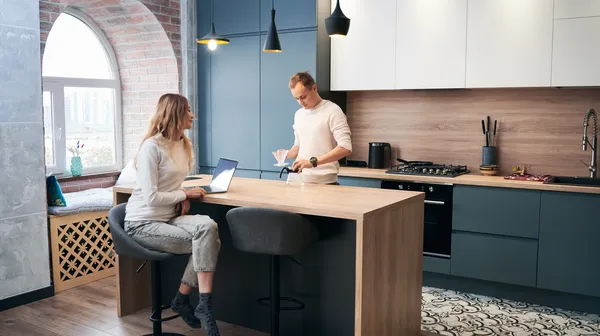 1768481978-woman-man-working-laptop-home-modern-kitchen