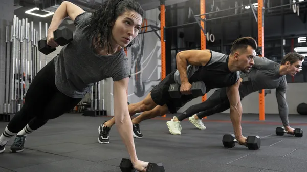 1769097514-people-working-out-indoors-together-with-dumbbells