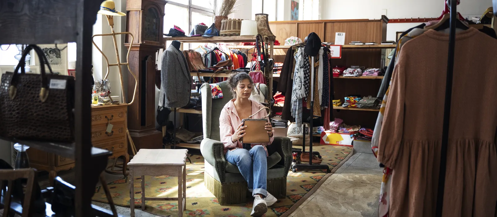 1769856834-woman-sitting-thrift-shop-full-shot