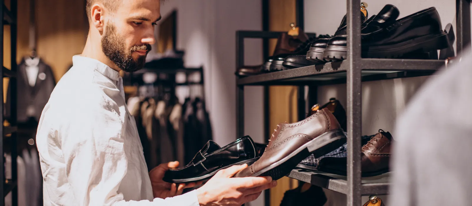 1770973265-man-choosing-foot-wear-mens-store