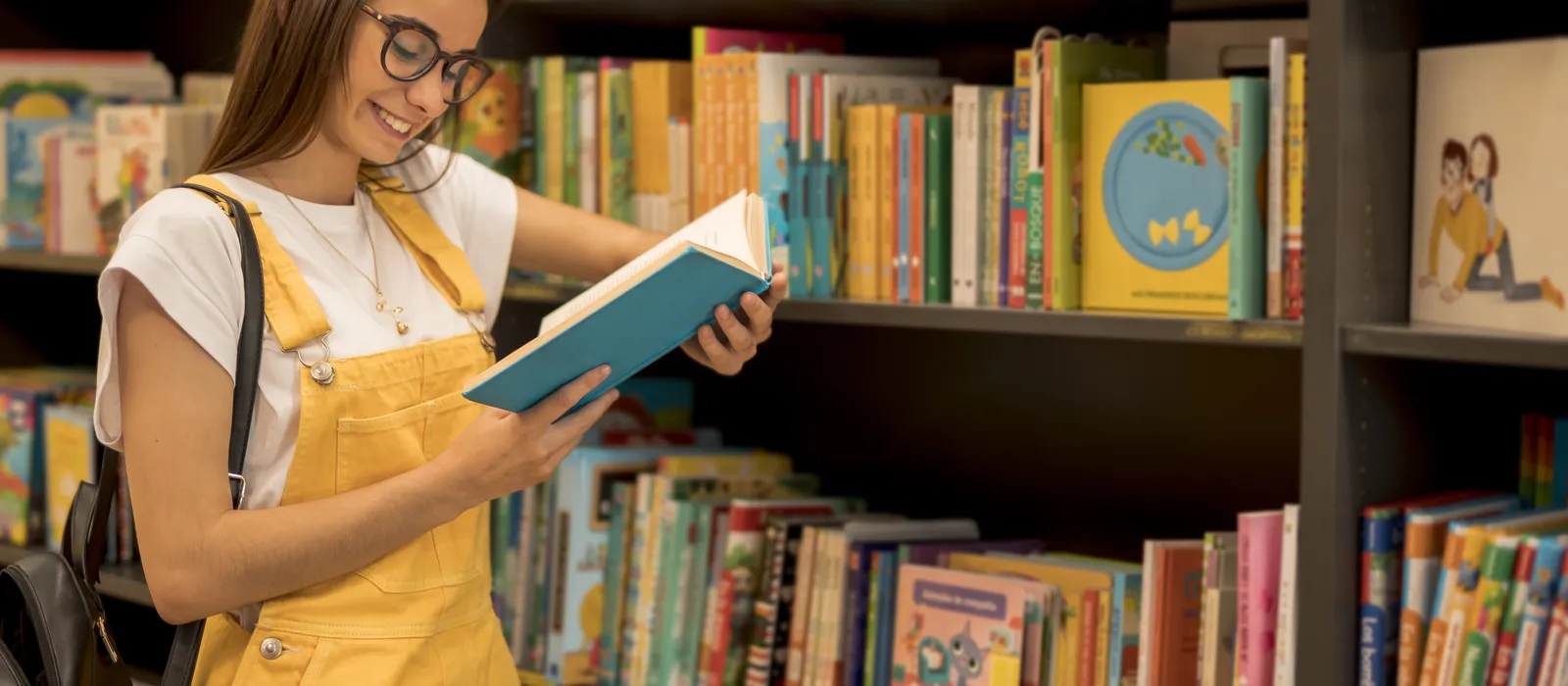 1763045053-teenage-student-reading-book-leaning-shelf