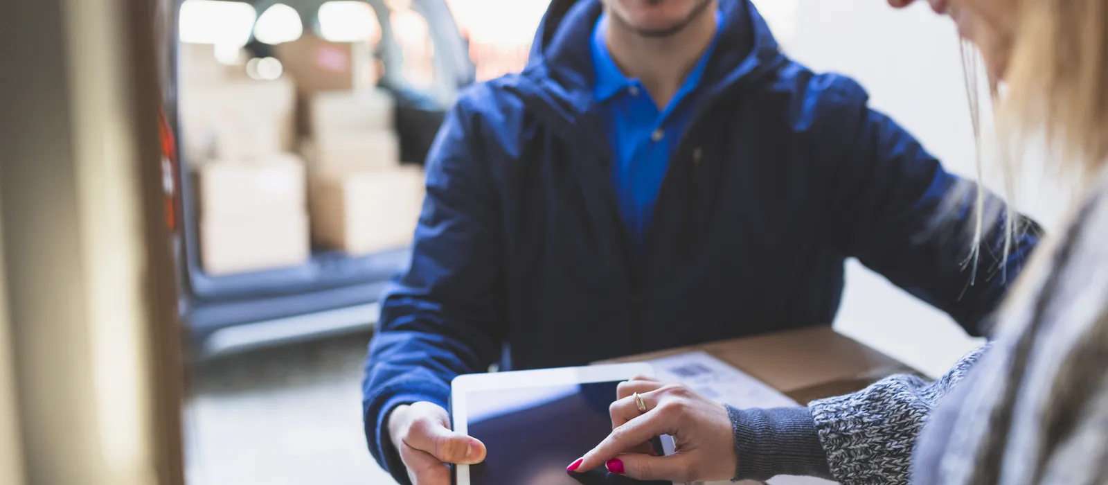 1763635979-woman-giving-online-signature-deliveryman