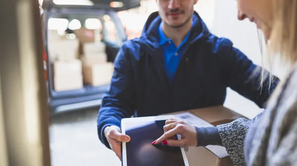 1763635979-woman-giving-online-signature-deliveryman