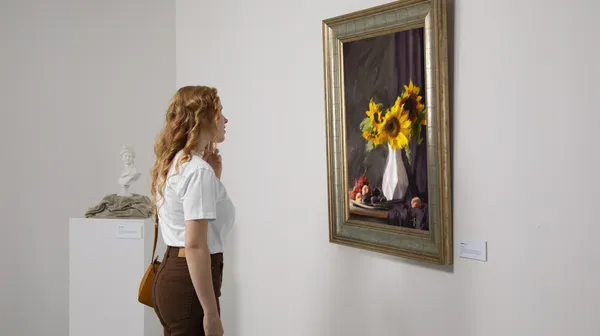 1769854316-side-view-woman-looking-painting