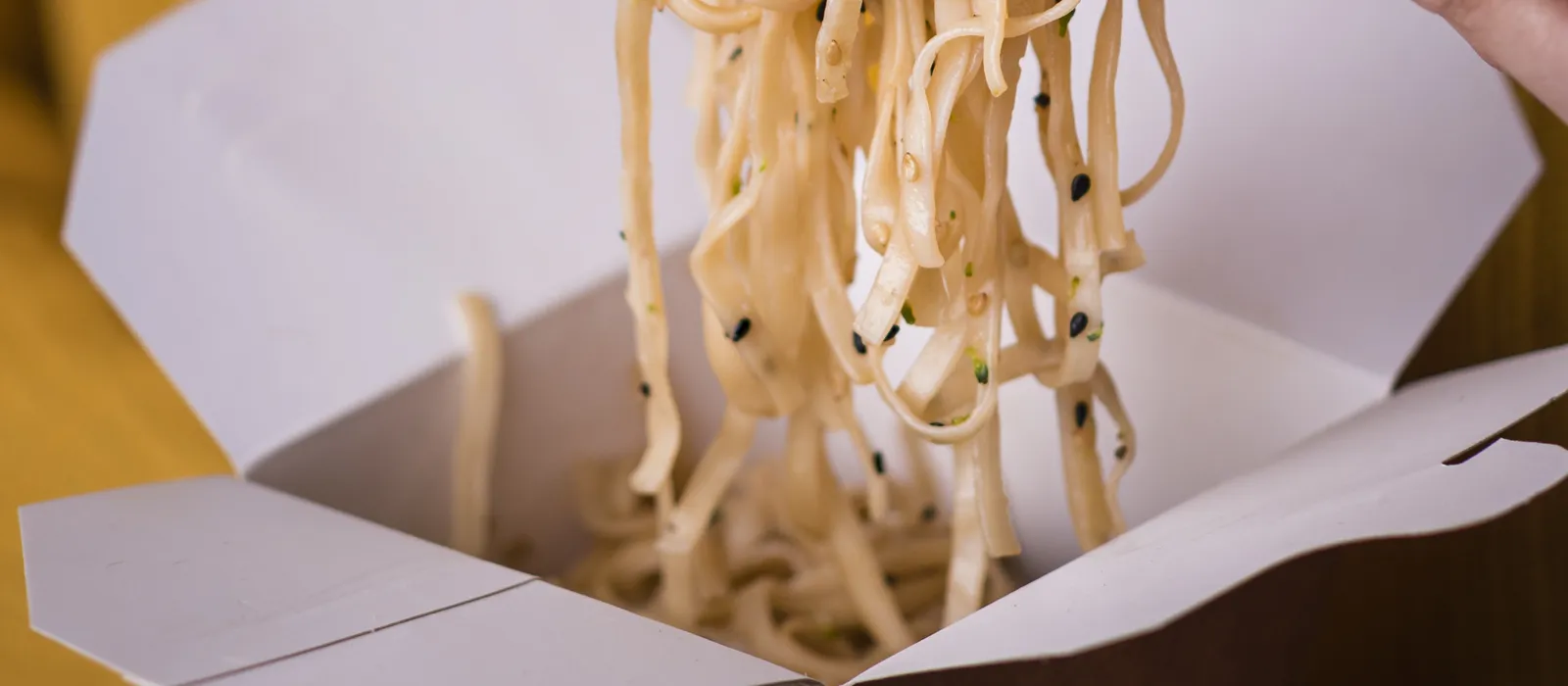 1770394184-woman-holding-noodles-chopsticks