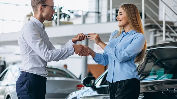 1775935698-customer-making-purchase-car-showroom