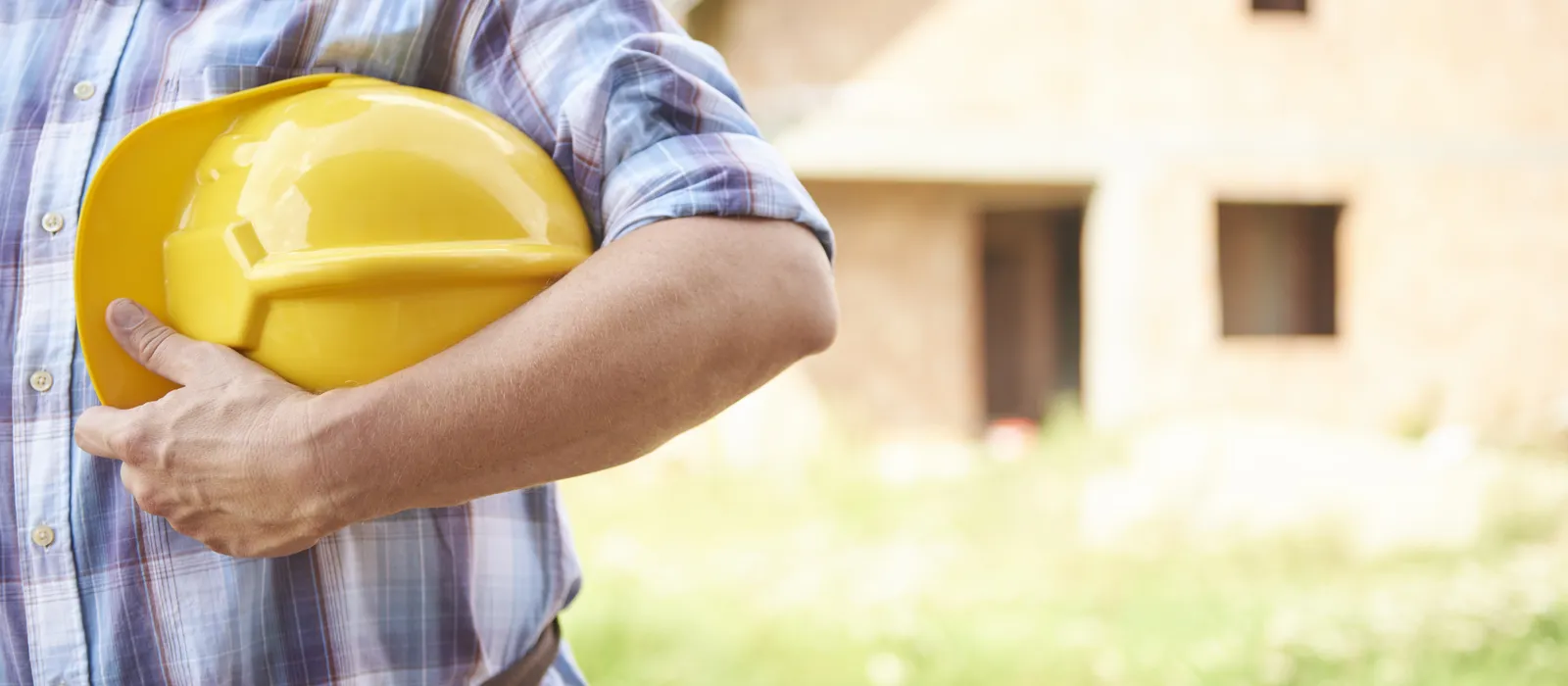 1776761875-close-up-man-holding-his-head-protector-outdoors