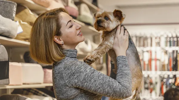 1778853547-woman-holding-cute-little-dog-pet-shop