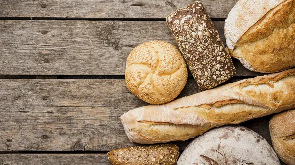 Bread buns top view with wooden background