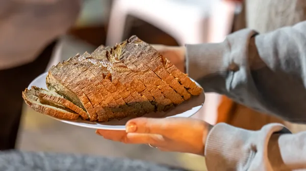 Plate with sliced bread female hands