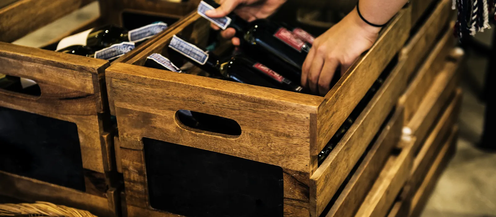 People hands getting bottle red wine