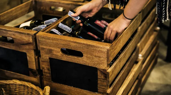 People hands getting bottle red wine