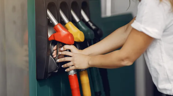 Elegant woman standing gas station