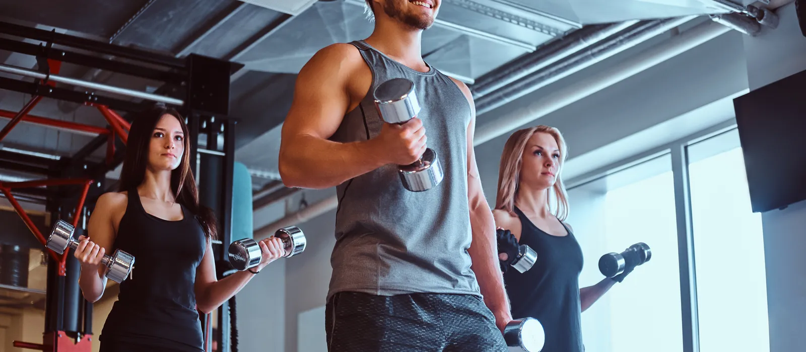 Group people exercising with dumbbells fitness club gym