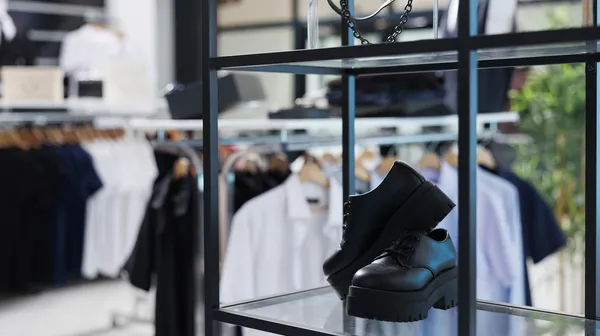 Empty shopping store with casual formal wear design retail shop with fashionable clothes hangers racks modern boutique clothing center fashion merchandise sale