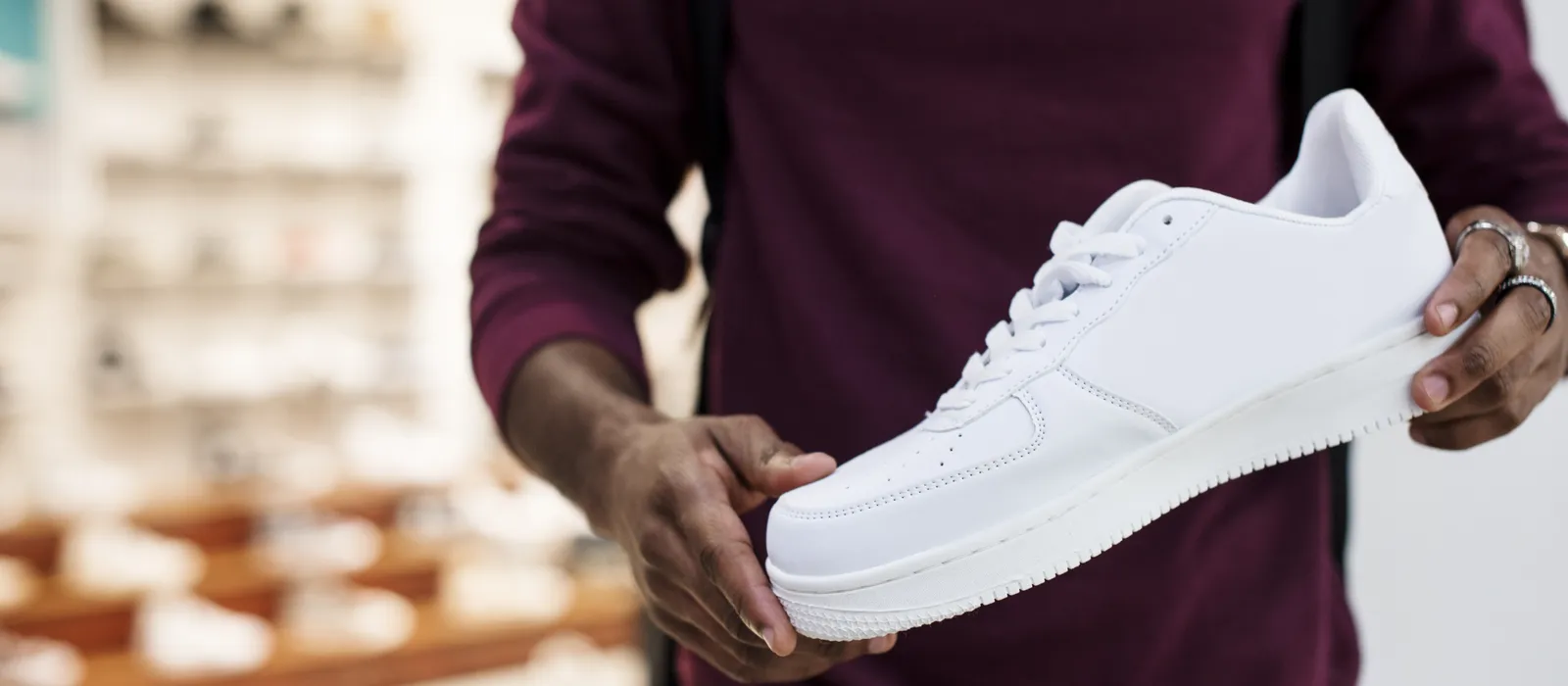 African man holding white sneaker