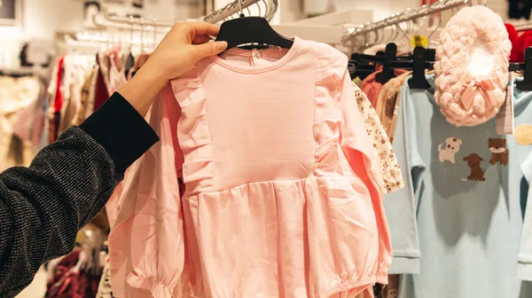 Little pink dress baby store mother doing shopping baby shop