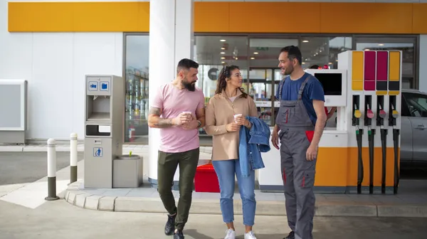 People spending time gas station