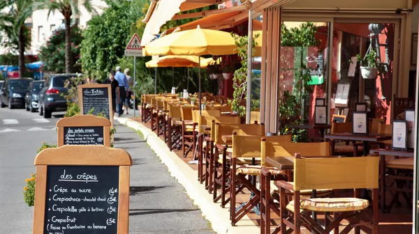 French restaurant scene with menu board
